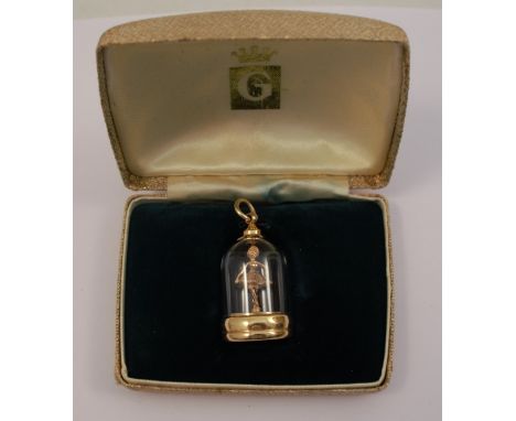 A 9 carat gold mechanical ballerina under glass charm, boxed, height to ring approx 1.25ins, diameter of base approx 0.75ins.