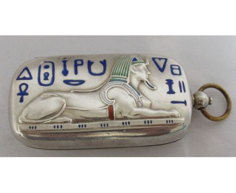 A white metal and enamel sovereign holder, of rectangular form, the lid embossed with a Sphinx and hieroglyphs, for full and 