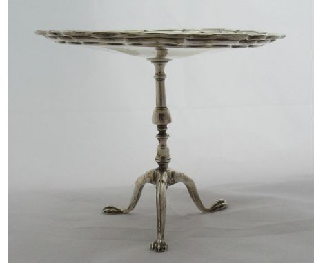 A silver miniature tripod table, the top with ogee border, raised on a turned column with three outswept legs on claw feet, L