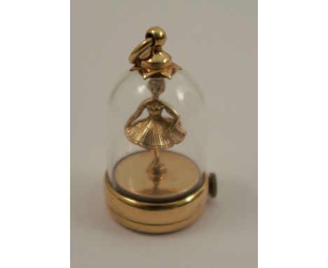 A 9 carat gold mechanical ballerina under glass charm,&nbsp;height to ring approx 1.25ins, diameter of base approx 0.75ins.Co