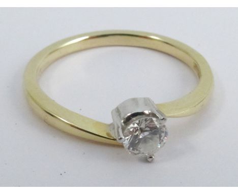 A single stone diamond ring, the mount with 750 convention mark, the brilliant cut stated to the shank as 'Apx .25ct', finger