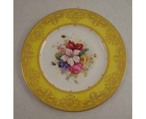 A Royal Worcester plate, decorated with a central floral panel of flowers by Spillsbury, to a yellow and gold border, circa 1