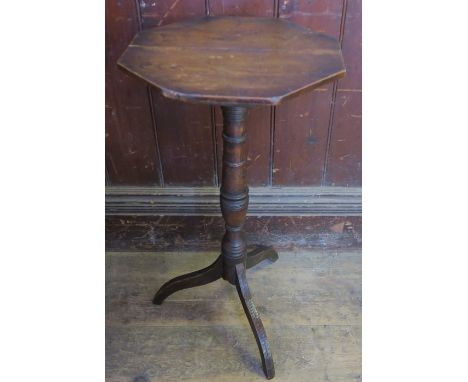 A 19th century octagonal topped elm country wine table, raised on a part ring turned column, terminating in an umbrella tripo