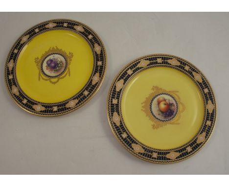 Two Art Deco style Royal Worcester plates, decorated with central panels of hand painted fruit by Bee and Seabright, to a dee