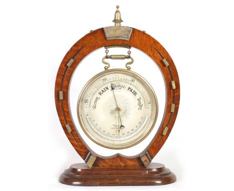 AN UNUSUAL LATE 19TH CENTURY ANEROID BAROMETER OF EQUESTRIAN INTEREST the oak and nickel mounted frame modelled as a horsesho