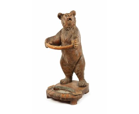 A GOOD 19TH CENTURY CARVED LINDEN WOOD BLACK FOREST BEAR STICK STAND OF UNUSUALLY LARGE SIZE standing holding a hooped branch