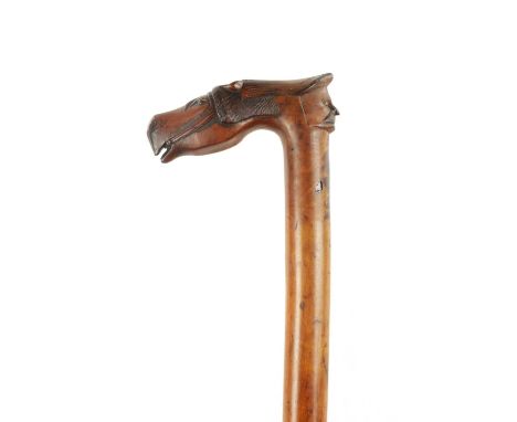 A 19TH CENTURY CARVED FRUIT WOOD FOLK ART WALKING STICK having a finely carved horses head and jockey handle92cm high 