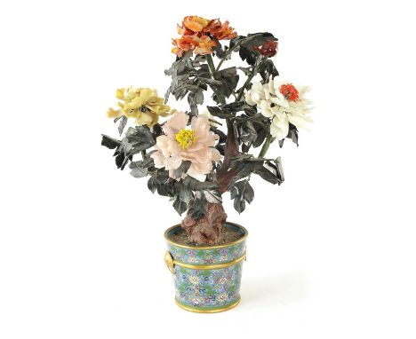 A 20TH CENTURY CHINESE JADE AND CARVED STONE FLOWER SCULPTURE in a cloisonné enamel jardiniere, having naturalistic branch wo