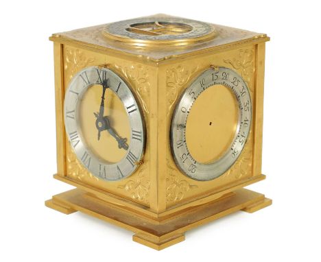 A 20TH CENTURY GILT BRASS REVOLVING DESK CLOCK COMPENDIUM the engraved case comprising of a compass, barometer, thermometer, 
