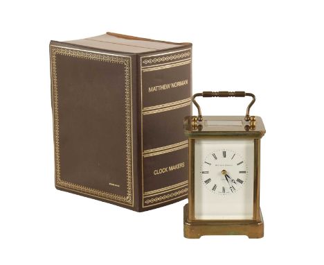 A MATTHEW NORMAN STRIKING CARRIAGE CLOCK with moulded brass case and enamel dial fronting an eight-day striking movement with
