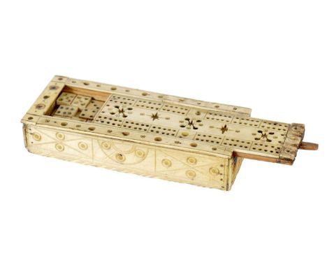 A 19TH CENTURY CARVED BONE PRISONER OF WAR GAMES BOX with slide off cribbage board revealing a set of dominoes15.5cm wide The