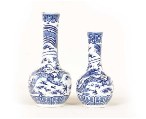 TWO 19TH CENTURY CHINESE BLUE AND WHITE PORCELAIN VASES both of bottle neck form decorated with dragon and stylised birds amo