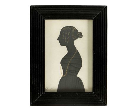 A 19TH CENTURY THREE QUARTER LENGTH SILHOUETTE PORTRAIT ON CARD depiciting a young lady with gilt highlights looking sinister