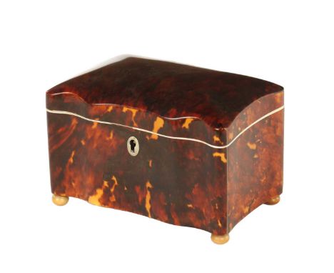 A 19TH CENTURY TORTOISESHELL AND IVORY SERPENTINE SHAPED TEA CADDY with hinged lid revealing two lidded compartments; raised 