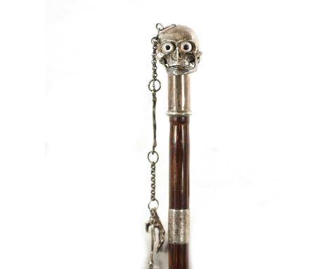 AN UNUSUAL 19TH CENTURY SILVER TOPPED WALKING STICK WITH HINGED SKULL POMMEL the solid silver top with hinged skull having at