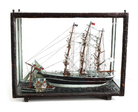 A 19TH CENTURY MODEL OF A TRIPLE MASTED SHIP BEING TUGGED IN BY A STEAMBOAT in a glazed wood case49cm wide 22cm deep 40cm hig