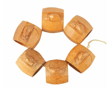 A GOOD SET OF SIX ROBERT 'MOUSEMAN' THOMPSON LIGHT OAK AND SLIGHTLY AZED SERVIETTE RINGS of circular form with curved panel e