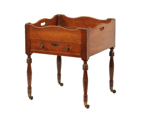 AN UNUSUAL GEORGE III MAHOGANY BUTLER'S STAND the wavey edge galleried top with cut-out handle slots above a single drawer wi