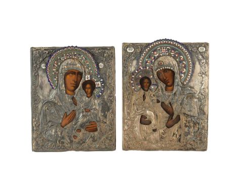 TWO EARLY SILVERED METAL AND ENAMEL DECORATED RUSSIAN ICONS depicting oil painted madonna and child32.5cm high 25cm wide and 