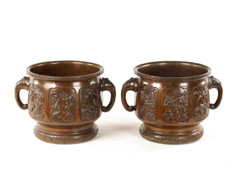 A PAIR OF JAPANESE MEIJI PERIOD BRONZE JARDINIERES with out-turned star engraved rims above the panelled decorated bodies dep