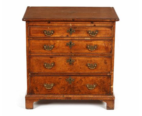 A GEORGE I HERRING-BANDED AND FIGURED WALNUT DRESSING CHEST the quarter veneered top above a slide and four long graduated dr