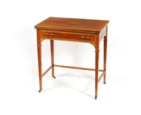 AN EDWARDIAN INLAID AND CROSS-BANDED MAHOGANY WRITING TABLE with hinged top, fitted interior and fold-out writing surface abo