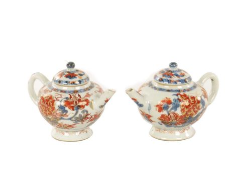 A PAIR OF 18TH CENTURY CHINESE IMARI SMALL TEAPOTS with traditional polychrome decoration high-lighted in gilding10cm high On