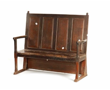 AN 18TH CENTURY SCUMBLED ELM AND PINE SETTLE with four fielded panel back and plank seat, raised open arms and sledge feet.14