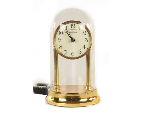 AN EARLY 20TH CENTURY ELECTRIC EUREKA MANTEL CLOCK having an enamel dial with Ararbic numerals fronting a brass battery power