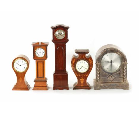 A COLLECTION OF FIVE EDWARDIAN MANTEL CLOCKS comprising two miniature longcase clocks, two inlaid mahogany examples and one s