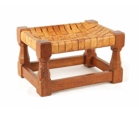 A ROBERT 'MOUSEMAN' THOMPSON HONEY COLOURED JOINED OAK FOOT STOOL with squared baluster tapering legs, under stretchers and w