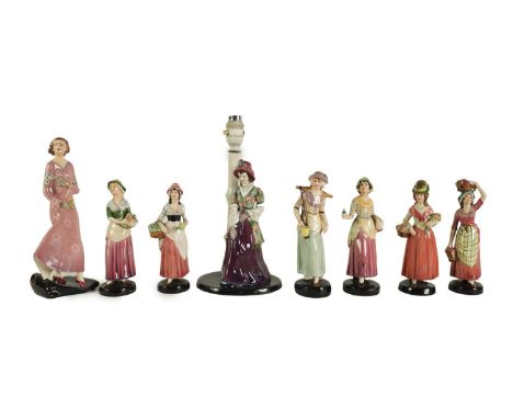 A COLLECTION OF EIGHT 20TH CENTURY STAFFORDSHIRE GOLDSCHEIDER FIGURES of young ladies, one mounted on a lampthe lamp 30cm hig
