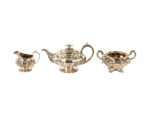 AN ASSOCIATED LATE GEORGIAN SILVER MELON-SHAPED THREE PIECE TEA SERVICE the bodies of fluted squat melon form with scrolling 