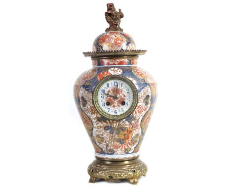 A 19TH CENTURY IMARI VASE CLOCK the shouldered tapering vase with domed lift off lid with foo dog final above a brass mounted