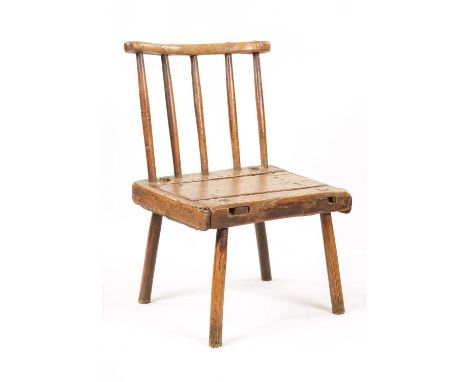 A EARLY 19TH CENTURY ELM AND PITCH PINE PRIMITIVE COMB BACK CHAIR with plank seat and stick legs.46cm wide 68cm high The chai