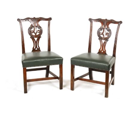 A PAIR OF 18TH CENTURY CARVED MAHOGANY CHIPPENDALE STYLE SIDE CHAIRS with leaf carved open pierced back splats, leather uphol