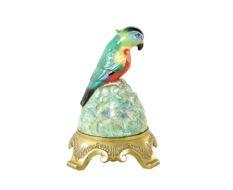 AN EARLY 20TH CENTURY ROYAL DOULTON ANDIA SPEAKER COVER MODELLED AS A PARROT on a brass shaped stand - bearing original label