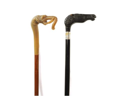A 19TH CENTURY EBONISED WALKING CANE AND ANOTHER ELEPHANT'S HEAD WALKING STICK the ebonised cane with silvered collar and car