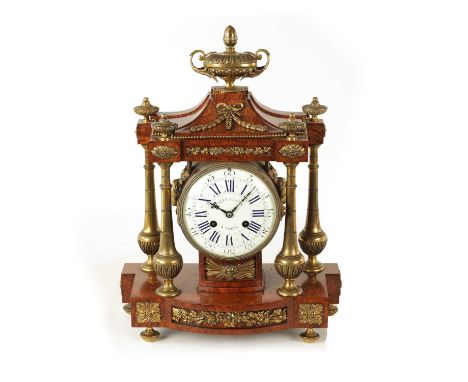 A LATE 19TH CENTURY FRENCH AMBOYNA AND ORMOLU MANTEL CLOCK surmounted by a large urn finial above a pagoda-shaped top with fo