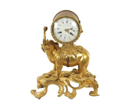 AN 18TH CENTURY FRENCH ORMOLU ELEPHANT MANTEL CLOCK the standing beast raised on a rococo naturalistic base, the saddle suppo