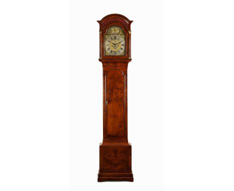 STEPHEN RIMBAULT, LONDON. A GEORGE II FIGURED WALNUT EIGHT DAY LONGCASE CLOCK the arched top hood with blind fretwork frieze 