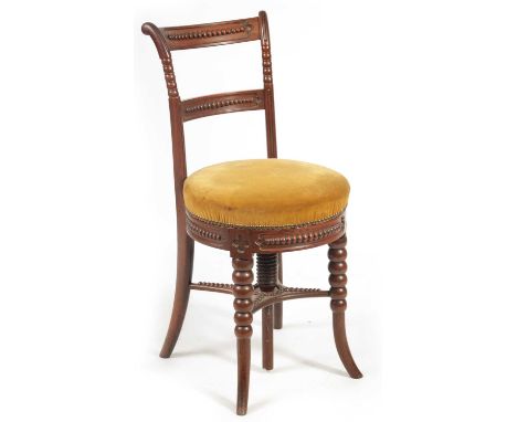 AN EARLY 19TH CENTURY MAHOGANY REVOLVING MUSIC CHAIR with bobbin-turned bowed back frame and upholstered circular seat; raise