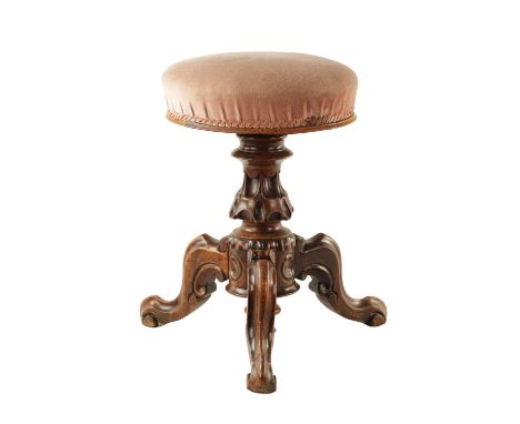 AN EARLY VICTORIAN CARVED WALNUT REVOLVING PIANO STOOL with tripod base and upholstered circular seat.46cm high closed down