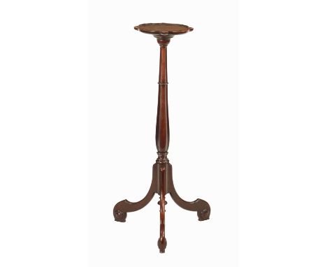AN EARLY GEORGE III MAHOGANY TORCHERE IN THE CHIPPENDALE MANNER the shaped circular top with carved floral detail above a rin