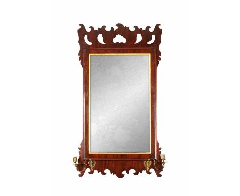 A 19TH-CENTURY MAHOGANY HANGING MIRROR with Chippendale style fretted surround and gilt wood slip; fitted brass candle holder