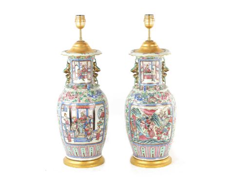 A PAIR OF 19TH CENTURY CHINESE FAMILLE ROSE VASES of ovoid form with flared scalloped neck and foo dog handles, decorated wit