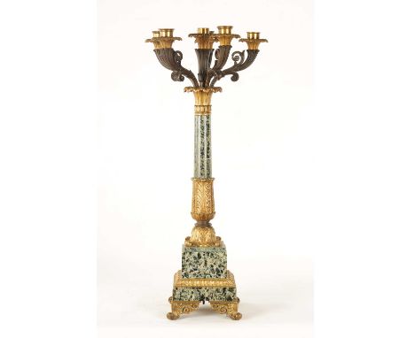 A REGENCY STYLE FRENCH ORMOLU MOUNTED VERDE GREEN MARBLE CANDELABRA the five branch top with center trumpet on a fine scrolle