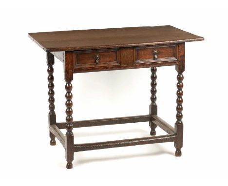 A LATE 17TH CENTURY OAK SIDE TABLE with overhanging top above a moulded frieze drawer; raised on bobbin turned legs joined un