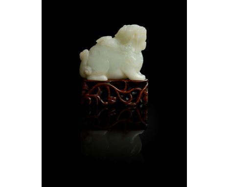  WHITE JADE BIXIE QING DYNASTY, 18TH CENTURY 清 白玉辟邪擺件 連木座carved seated with head turned slightly to the right, surmounted by 