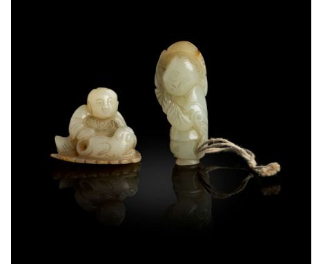  TWO PALE CELADON JADE WITH RUSSET SKIN CARVINGS OF BOY AT PLAY QING DYNASTY, 19TH CENTURY 清 青白玉雕嬰戲把件（共兩件）one carving of a se